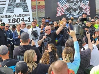 Dennis Daggett, Executive Vice President of the ILA, speaking into a microphone at the strike in 2024